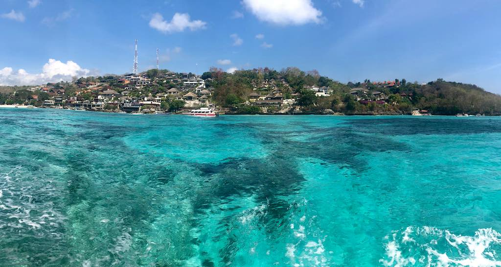 Aerial drone view of turquoise reef and island in Bali