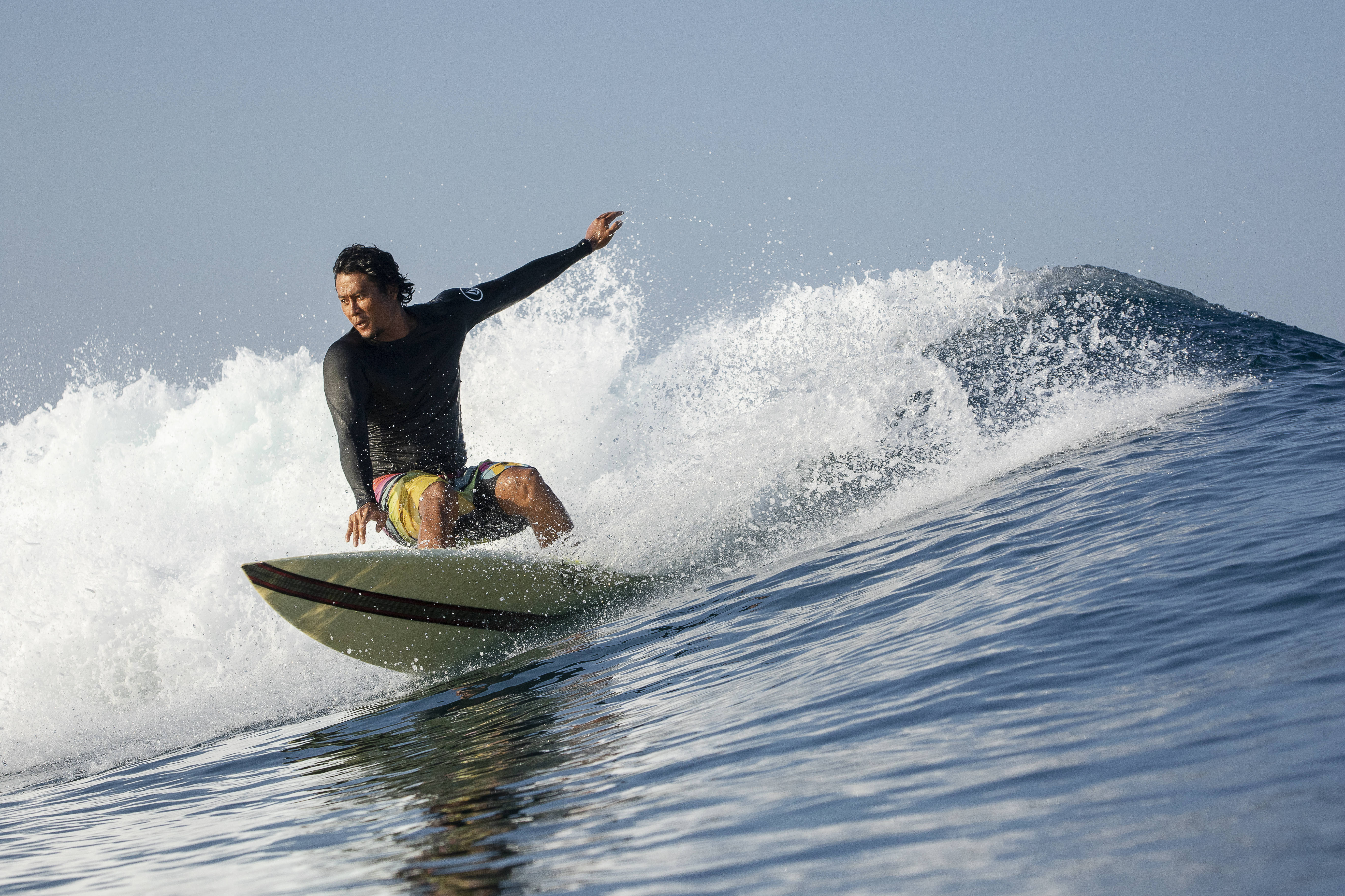 Surfer doing a cutback with spray at Kuta Reef