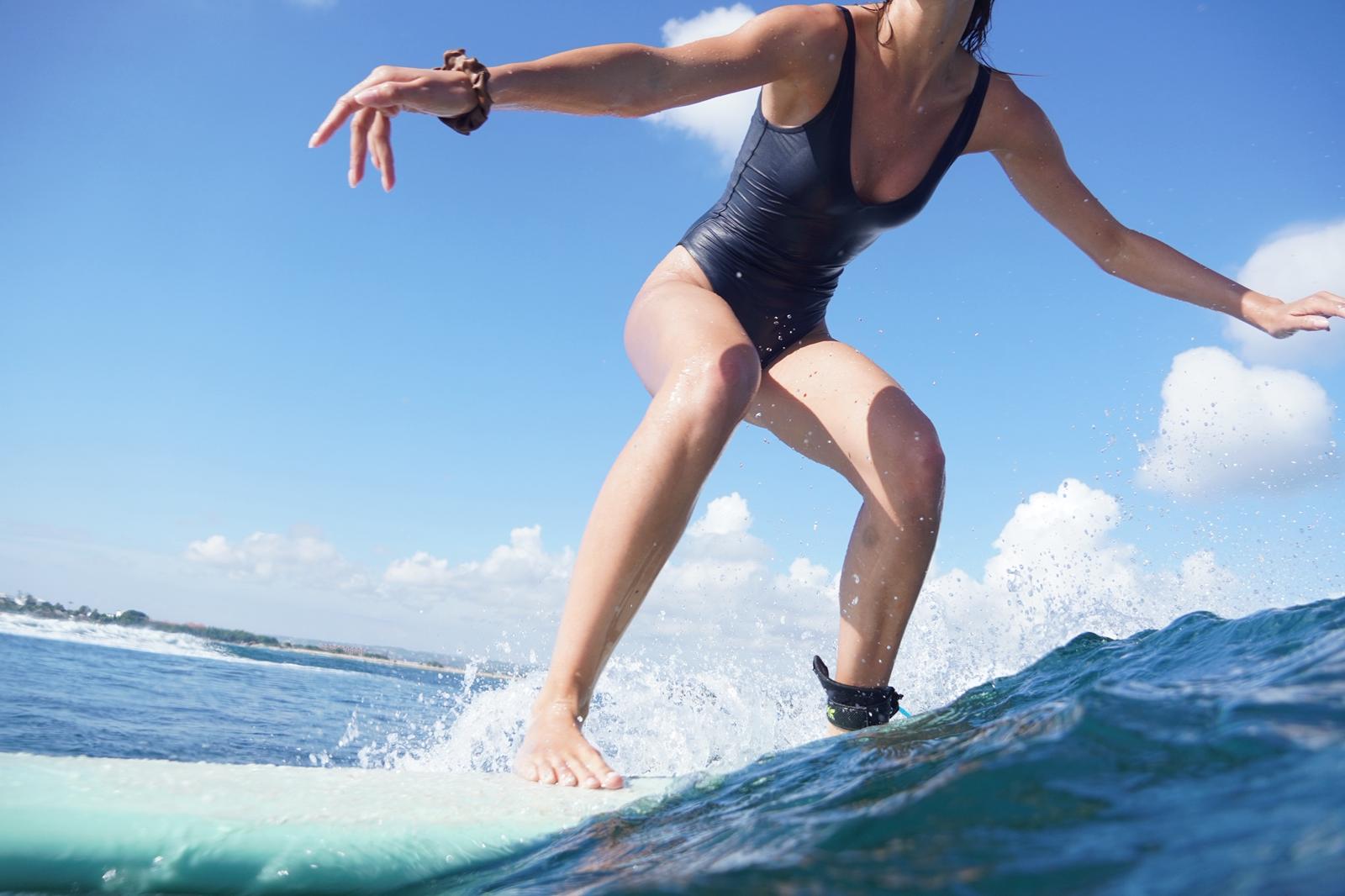 Close-up of a surfer walking the board on a wave