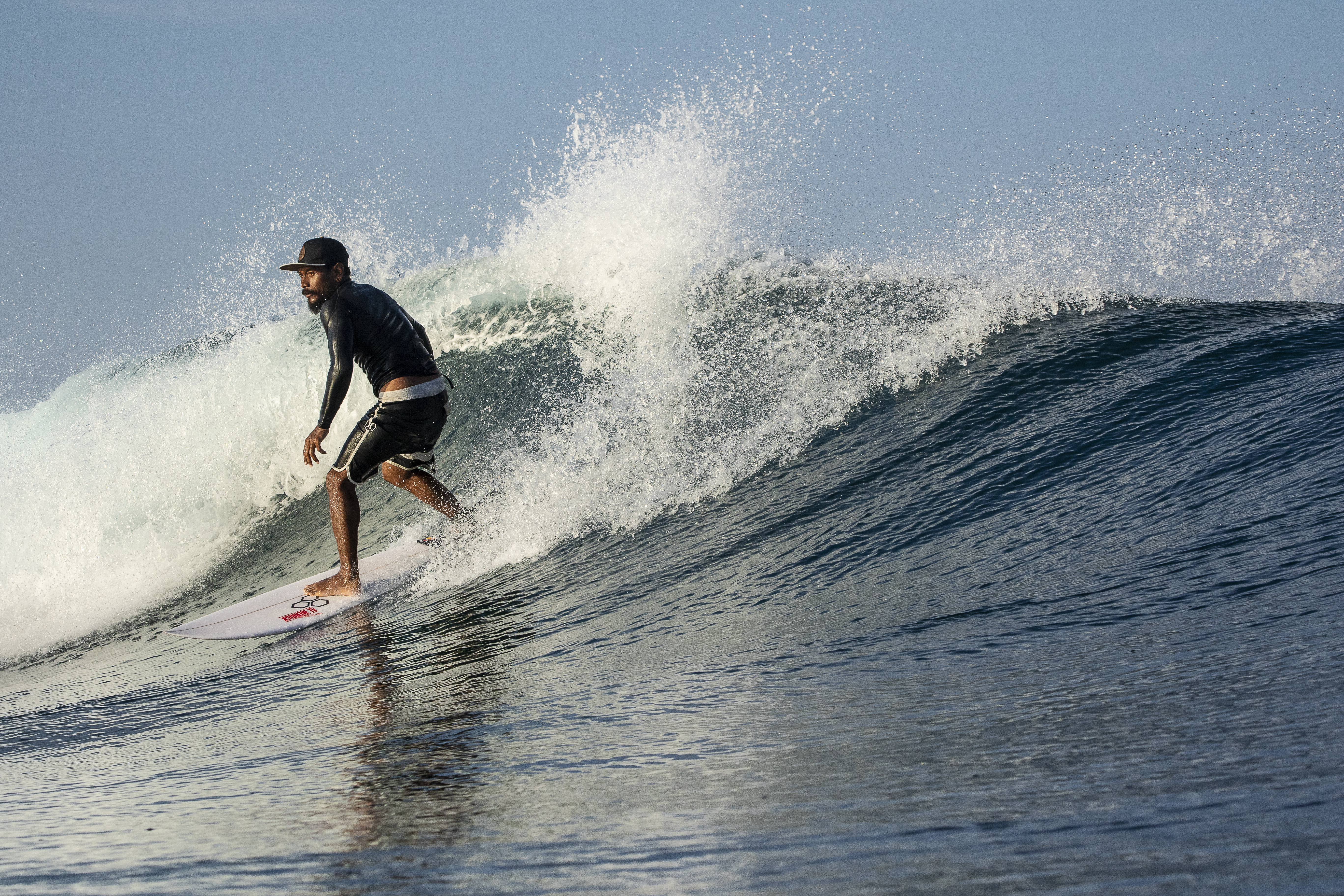 Clean left-hand wave peeling across Kuta Reef on a glassy morning